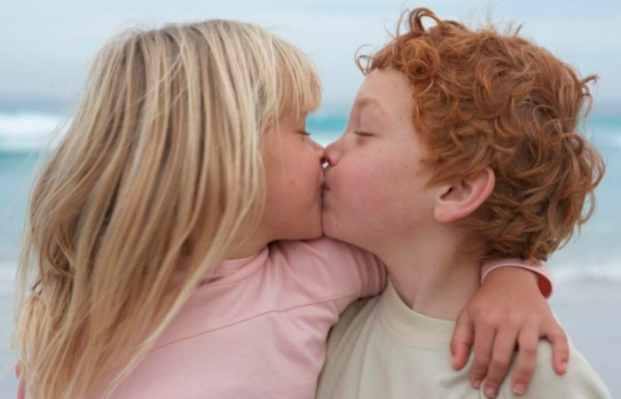 una niña y un niño se besan en la boca. Los besos en la boca entre niños no entrañan grandes preocupaciones