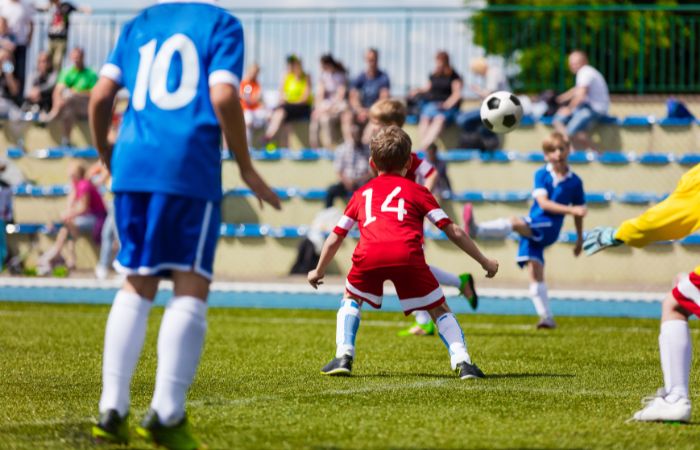 Padres en las gradas de futbol infantil